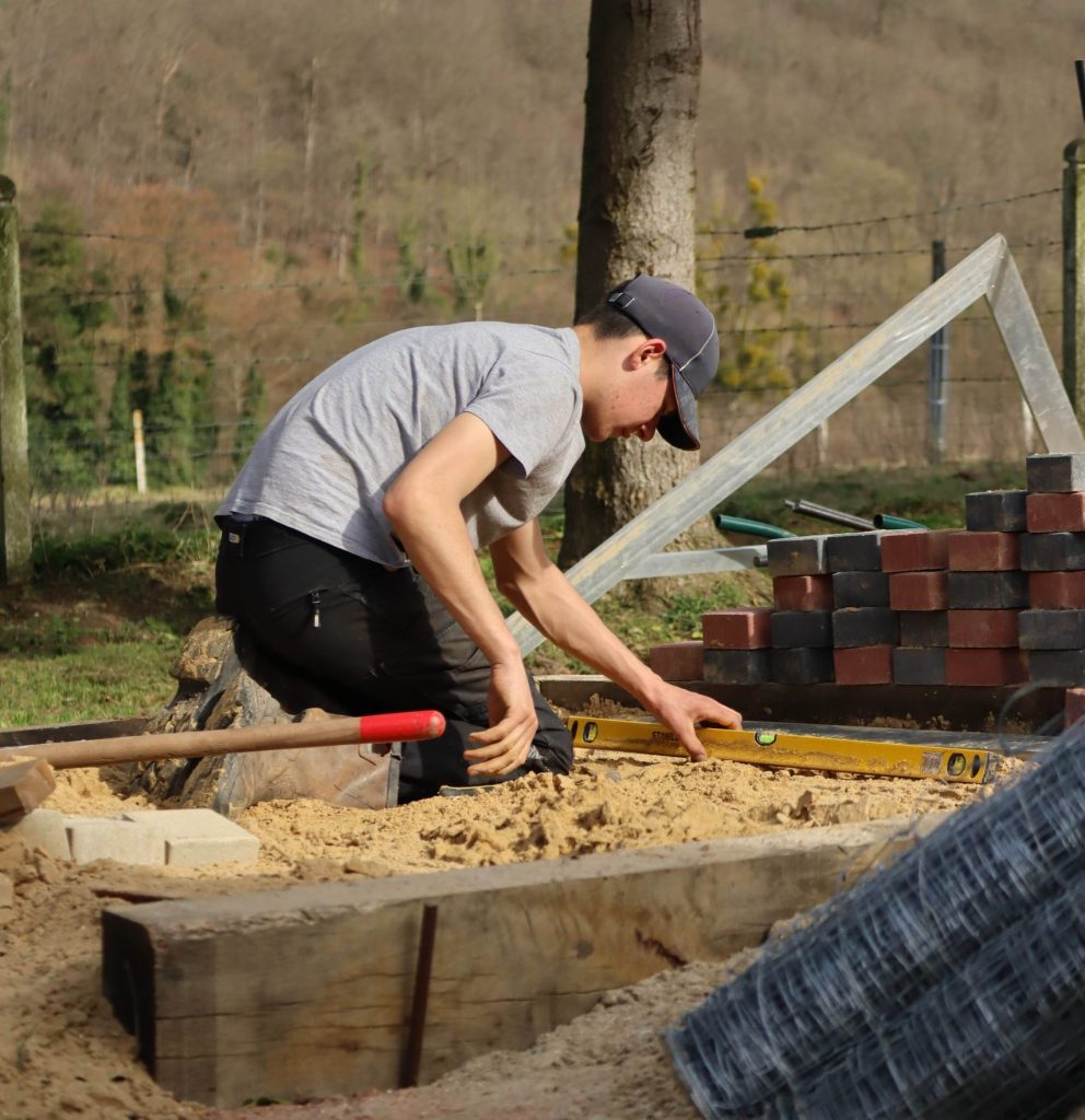 Élève en BP Aménagements Paysagers réalisant un travail de couverture pour un parterre au Lycée Agricole Privé de Tourville-sur-Pont-Audemer